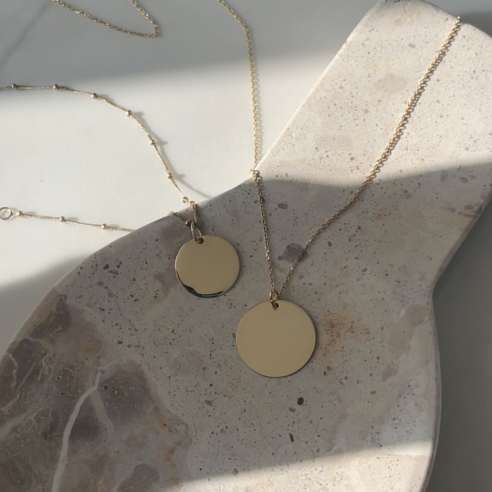 Sphere chain pendant bracelet next to pendant necklace for memorial fingerprint jewelry