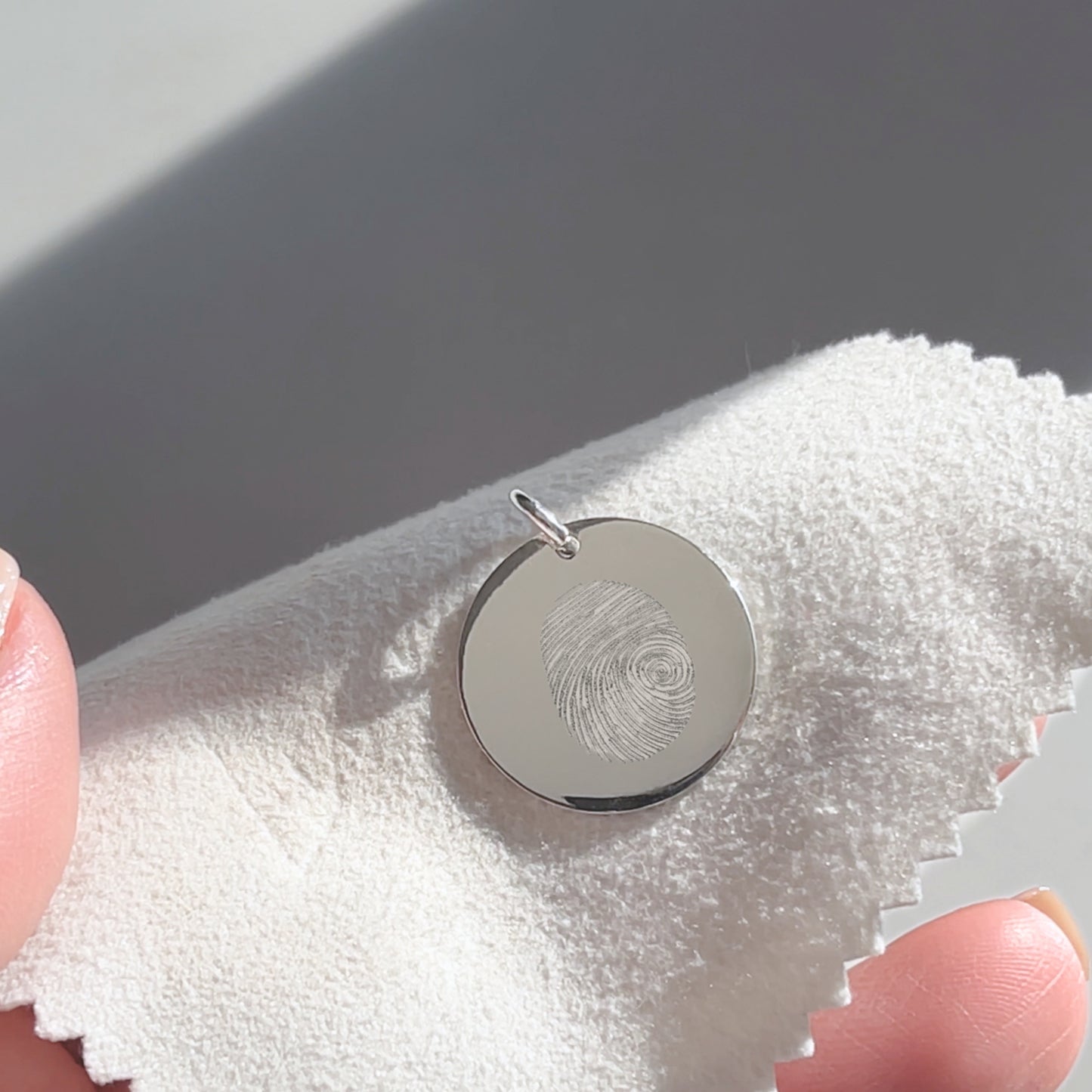 Woman holding a 925 Sterling Silver Actual Fingerprint Personalized Custom Memorial Engraved Pendant