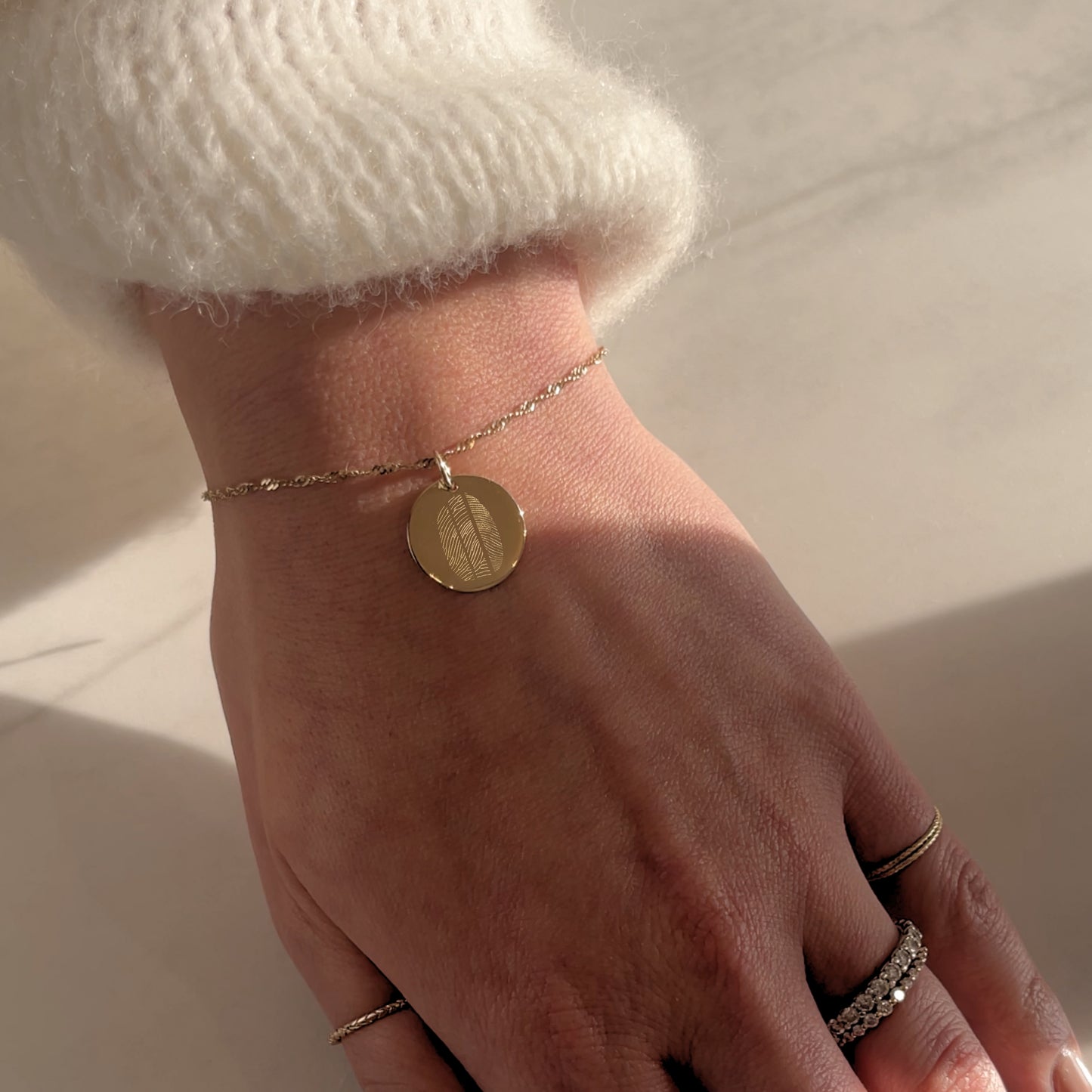 Woman's wrist with 10K solid gold Actual Three Fingerprint Memorial Engraved Bracelet with Twisted chain