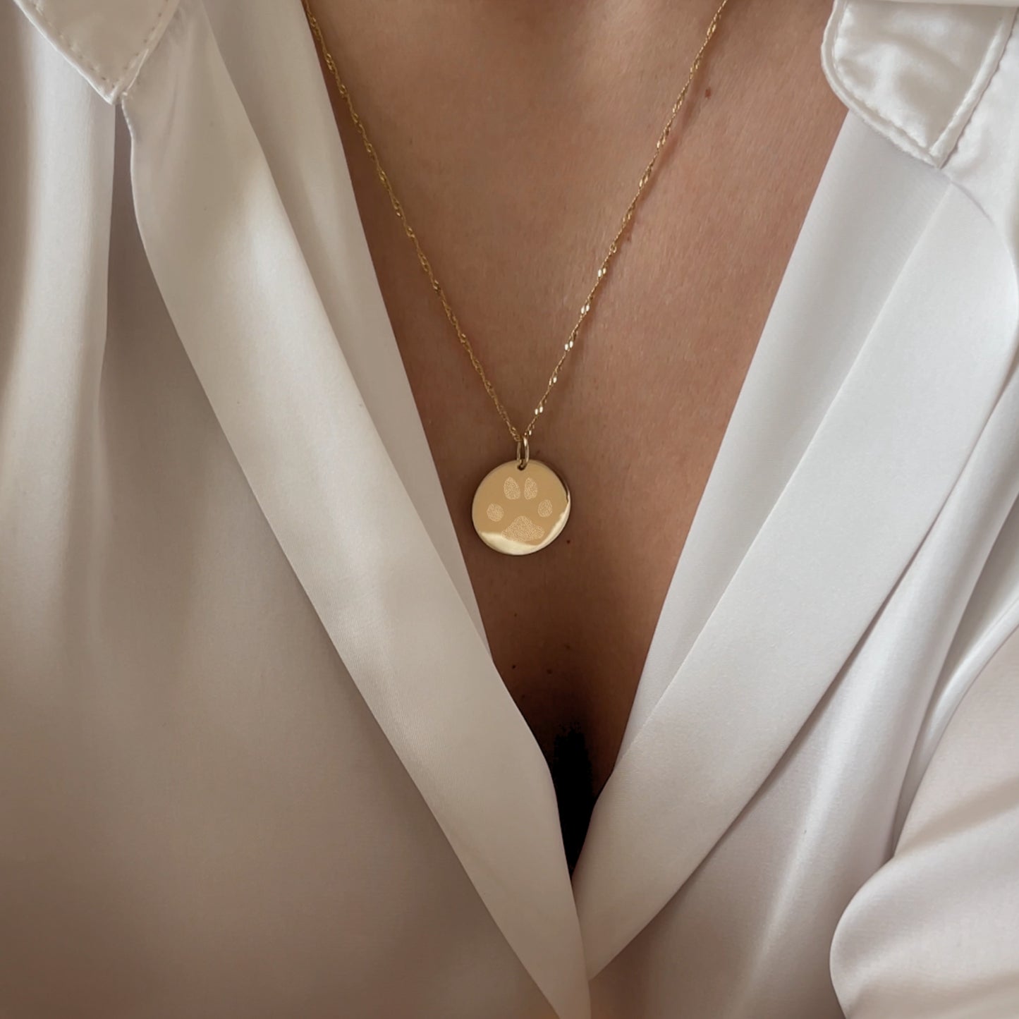 Woman wearing 10K solid gold Actual Dog’s Paw print Custom Memorial Engraved twisted chain necklace