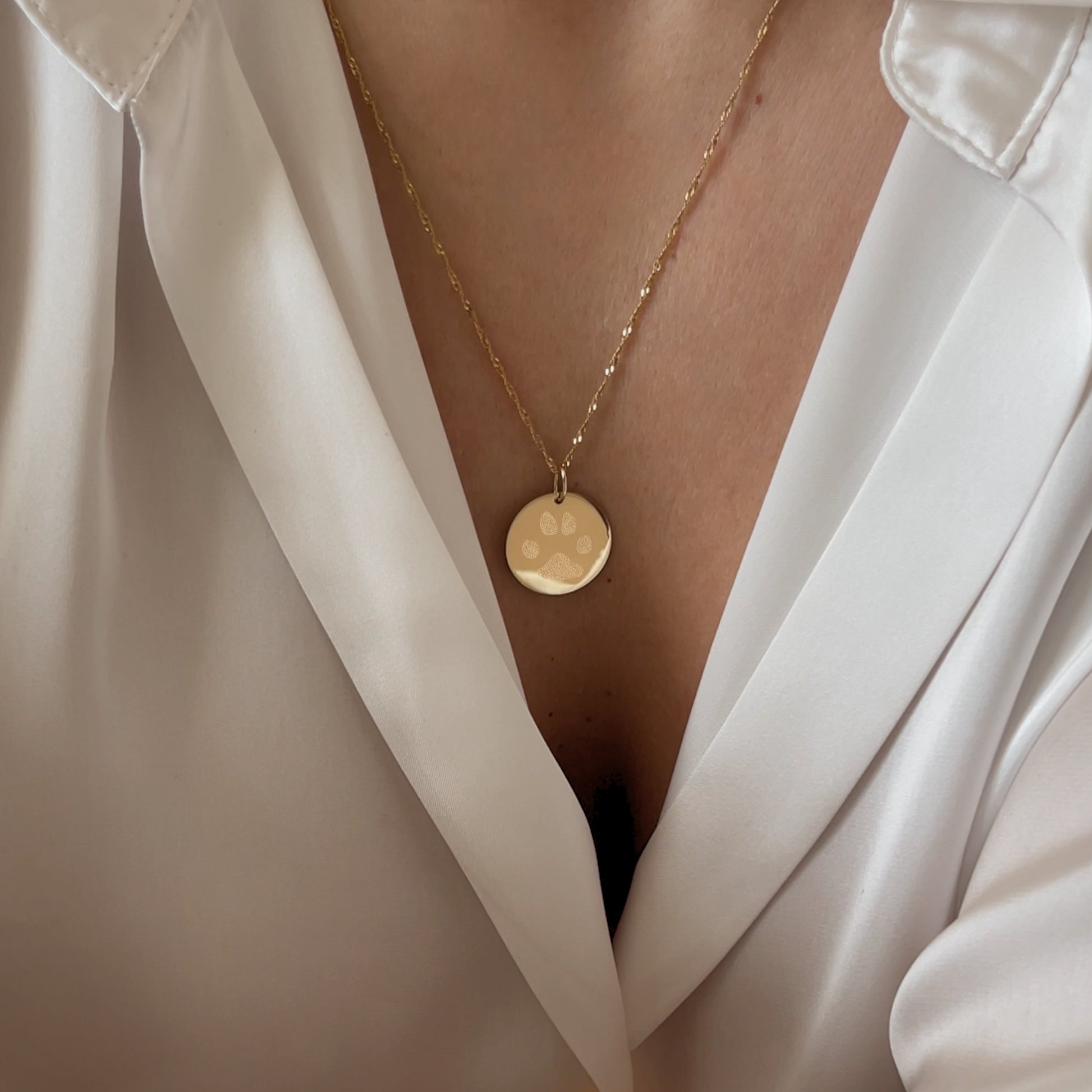 Woman wearing 10K solid gold Actual Dog’s Paw print Custom Memorial Engraved twisted chain necklace