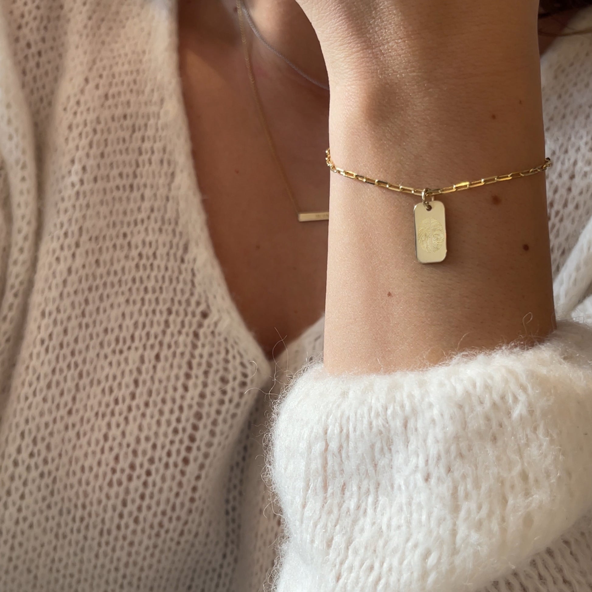Woman wearing a 10K Solid Gold Two Fingerprint Paperclip bracelet with pendant
