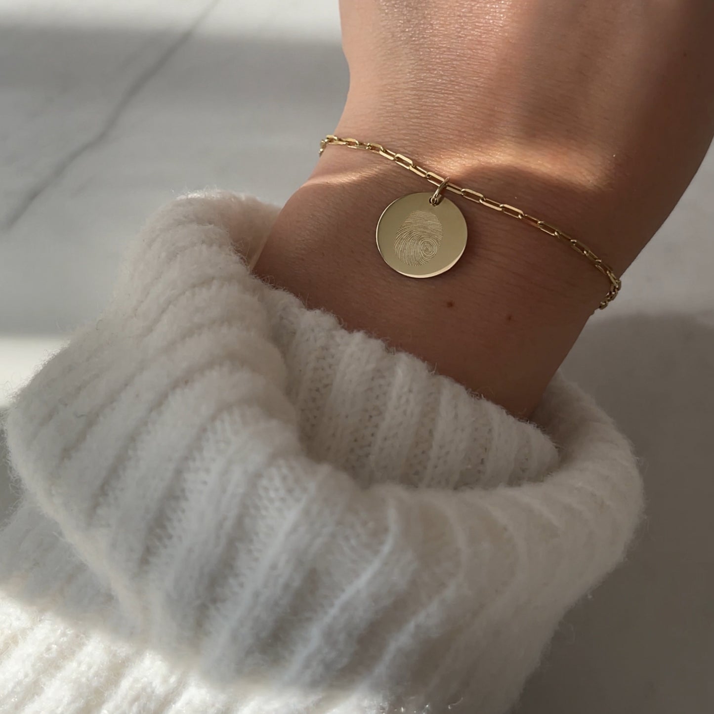 Woman wearing a 10K solid gold Actual Fingerprint Custom Memorial Engraved Paperclip Bracelet