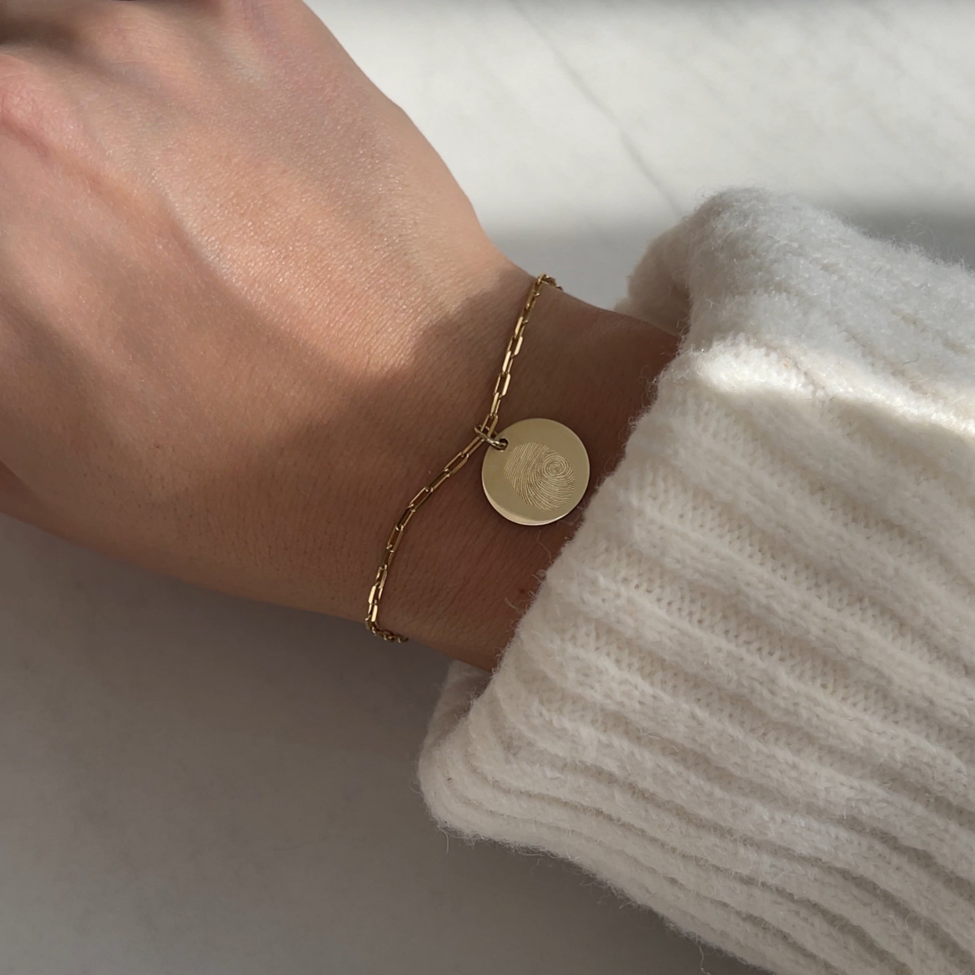 Woman wearing a 10K solid gold Actual Fingerprint Personalized Memorial Engraved Paperclip Bracelet