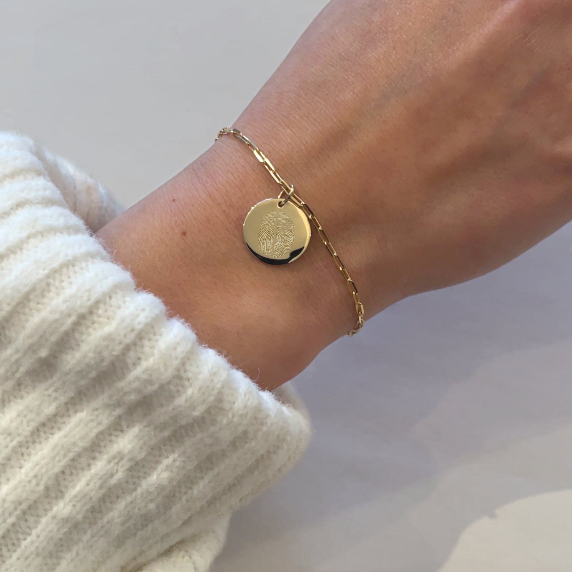 Woman wearing a 10K solid gold Actual Two Fingerprint Personalized Custom Memorial Engraved Paperclip Bracelet