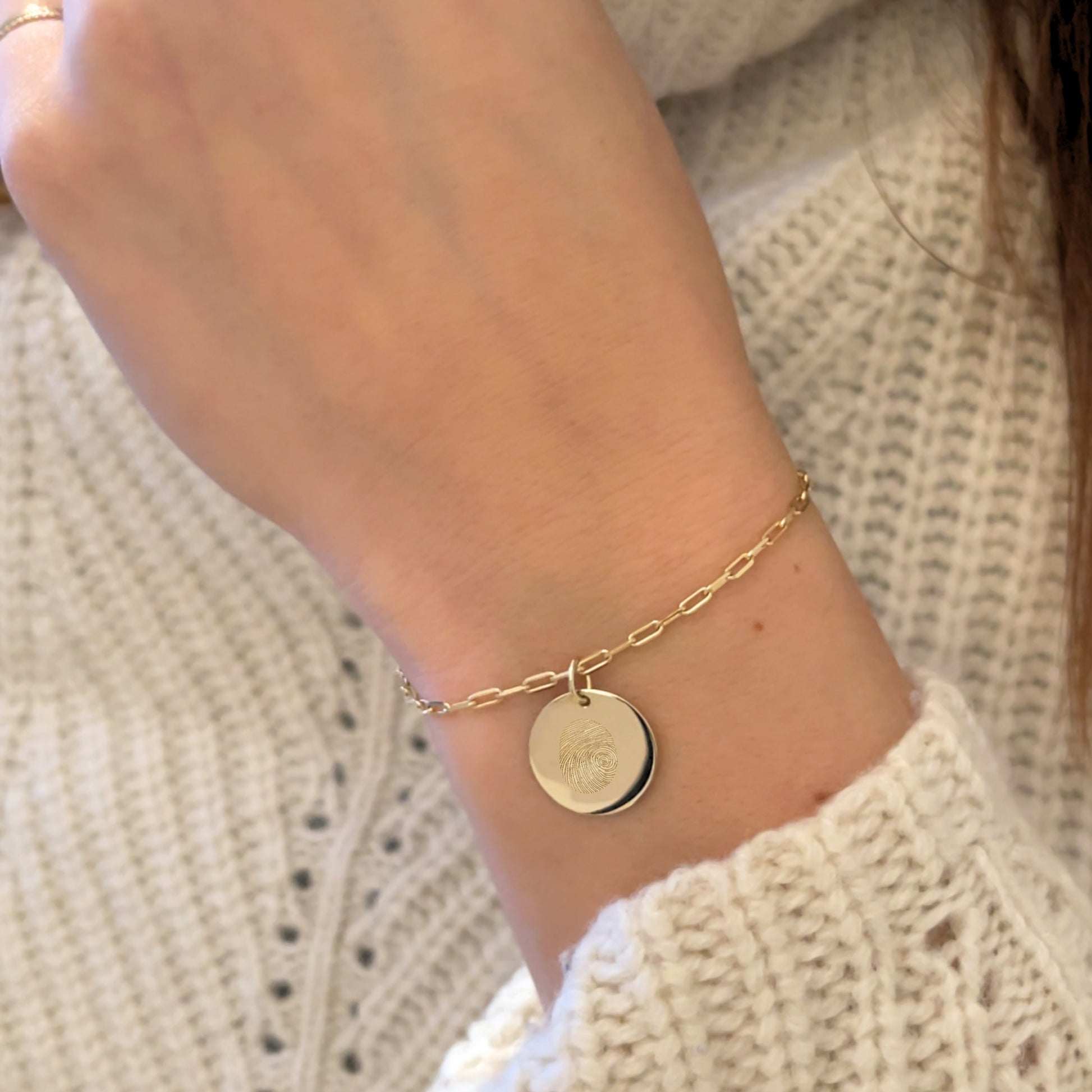 Woman wearing an actual fingerprint paperclip bracelet