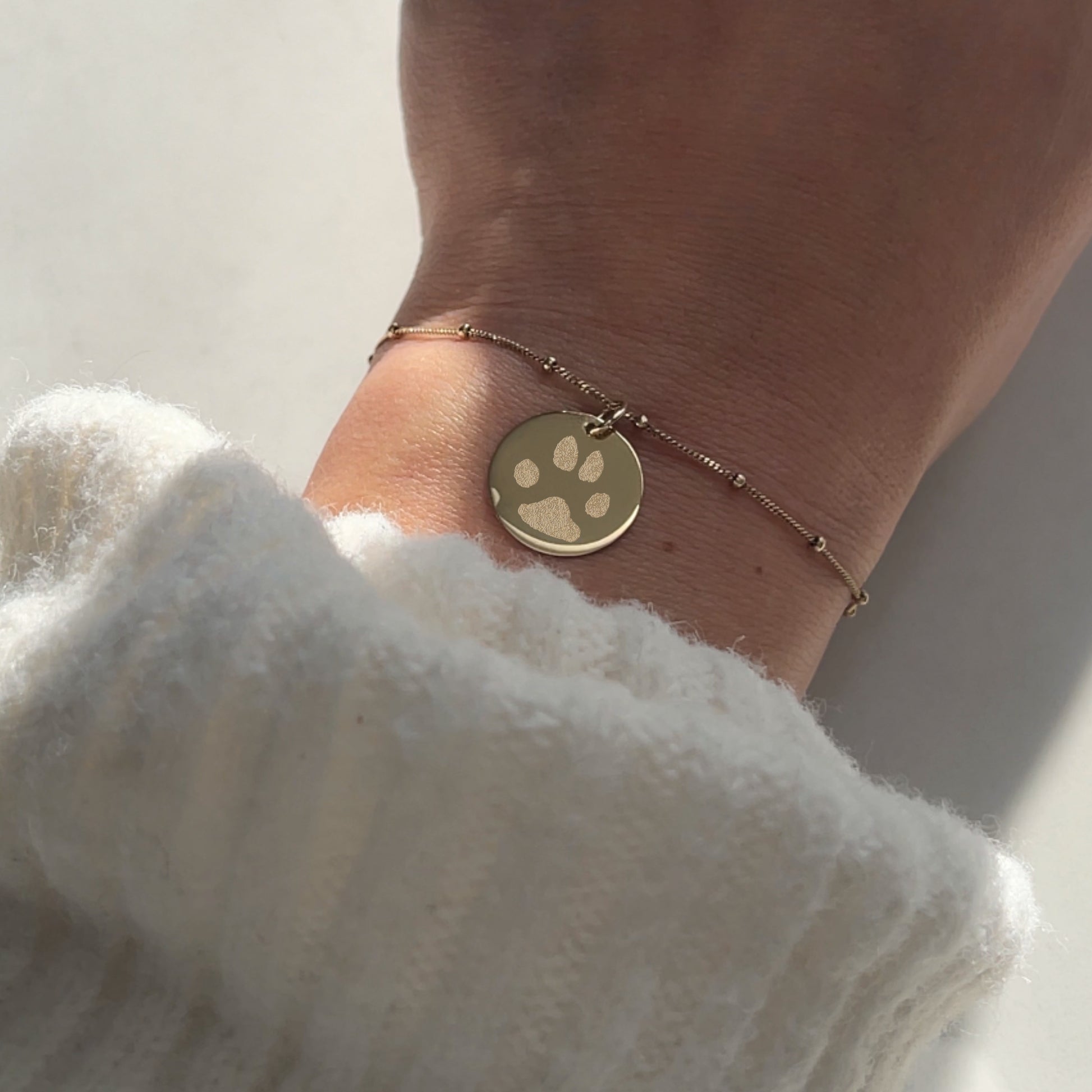 woman wearing 10K solid gold Actual Dog’s Paw print Custom Engraved Bracelet