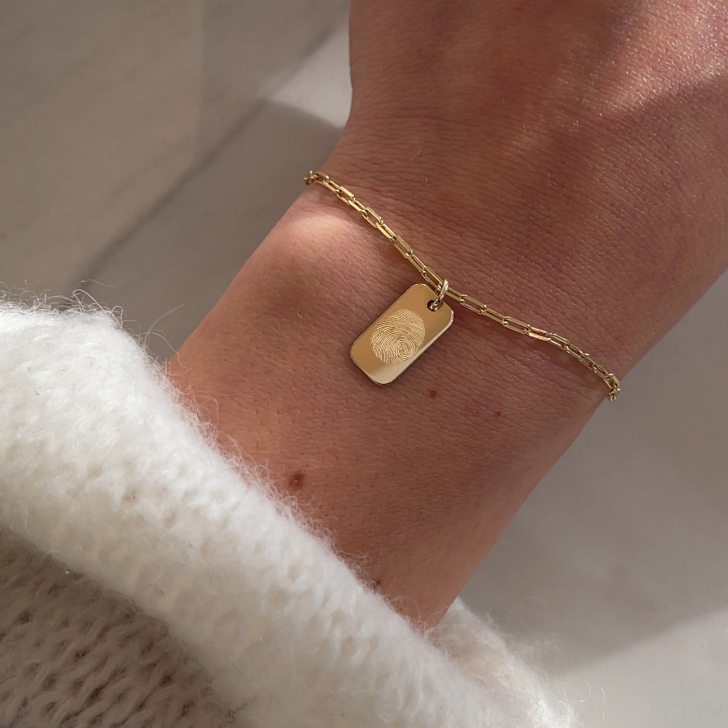 woman wearing a 10K solid gold Actual Fingerprint Personalized Custom Memorial Engraved Rectangle Paperclip Bracelet