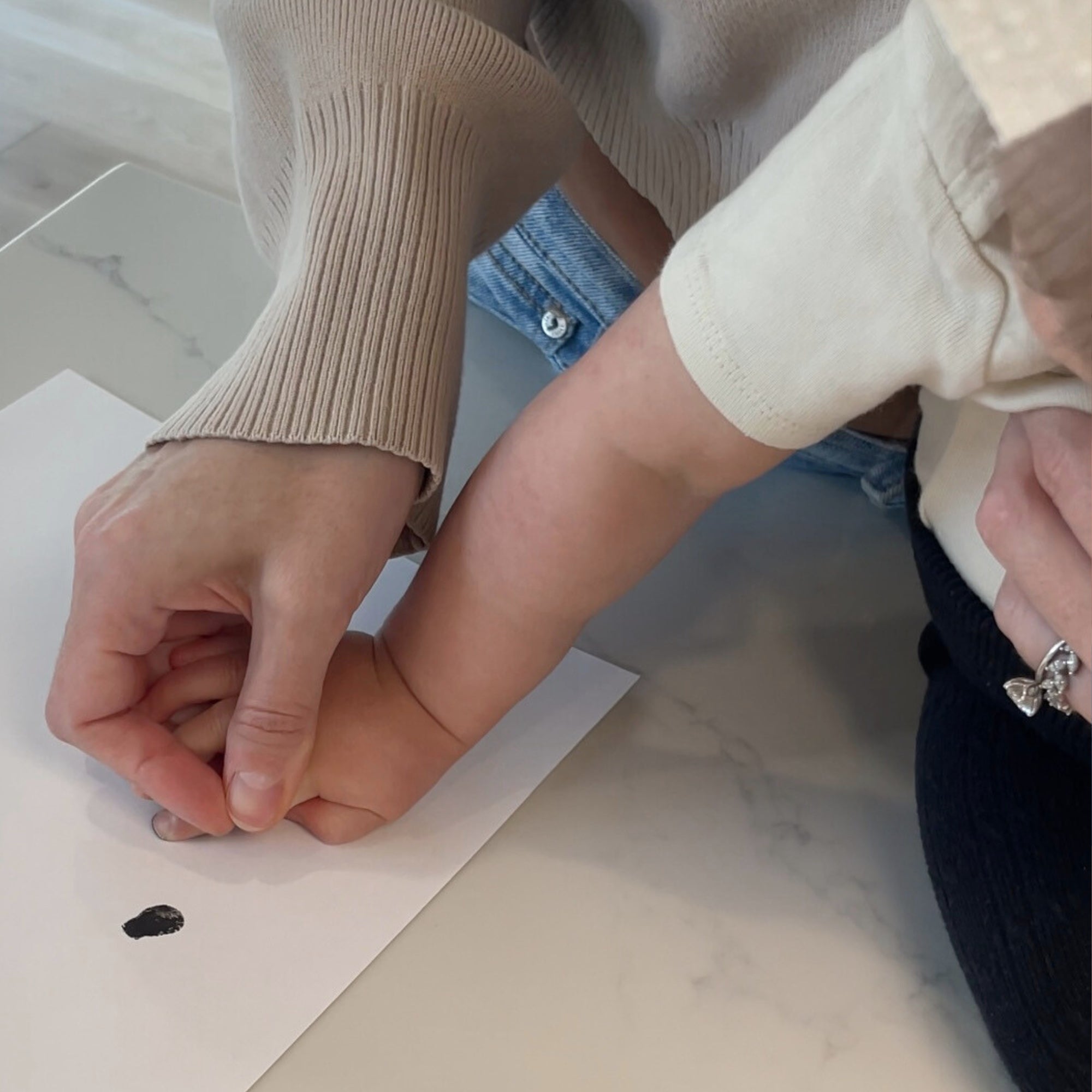 Mom taking baby's fingerprint for memorial fingerprint pendant jewelry