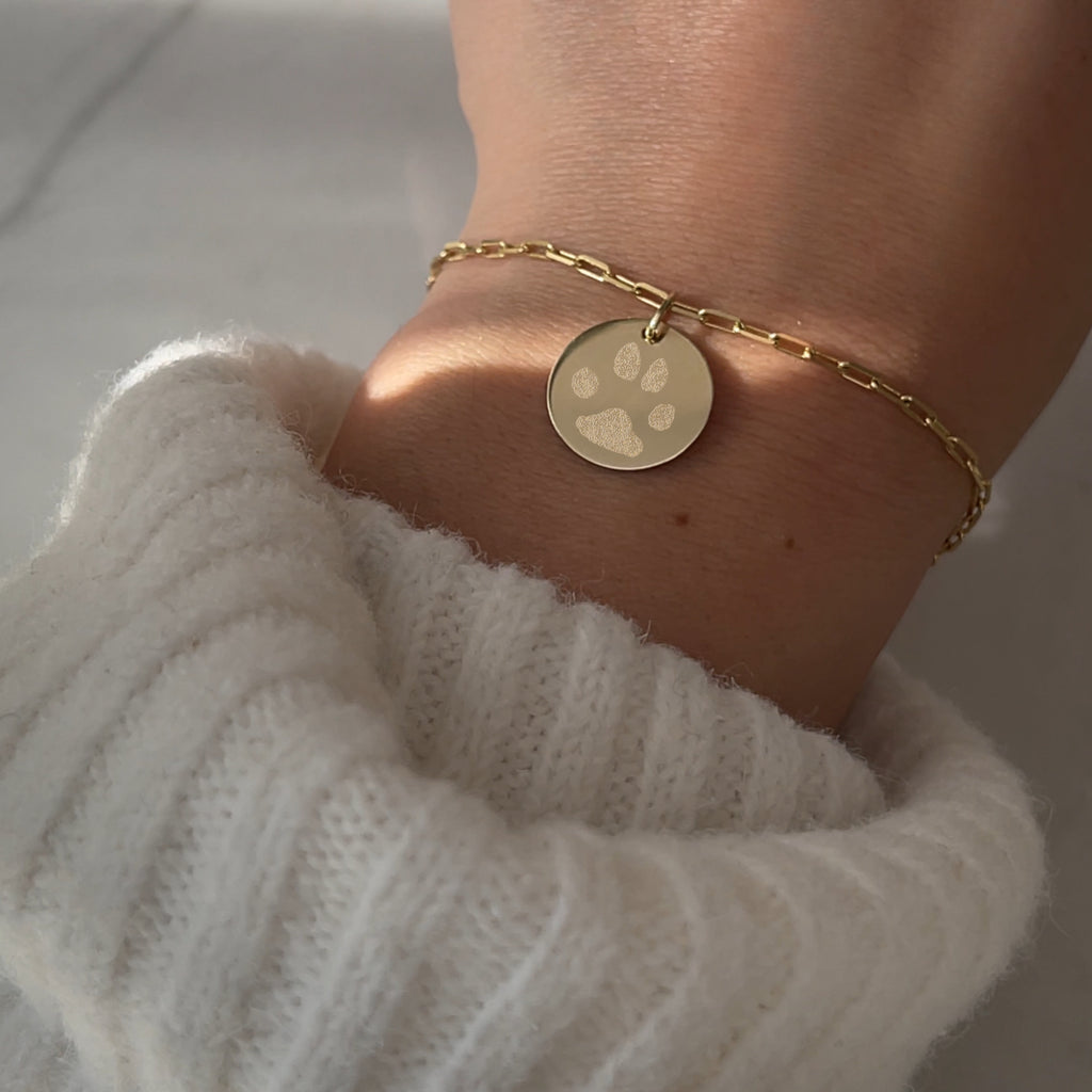 Woman wearing 10K solid gold Actual Dog’s Paw print Custom Memorial Engraved paperclip bracelet
