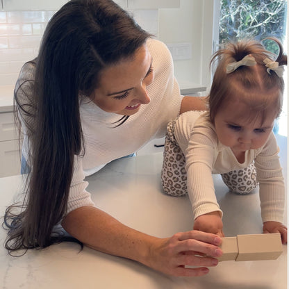 mom with baby opening her one of a kind memorial jewelry gift
