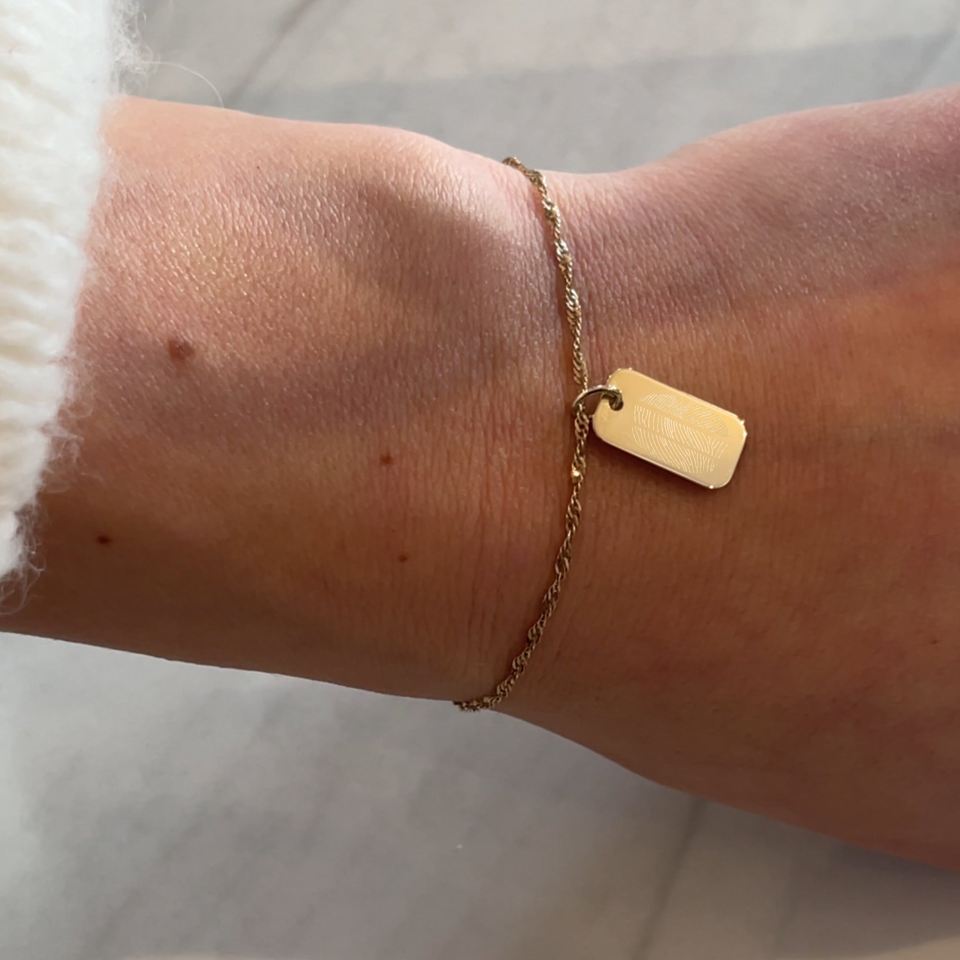 woman wearing 10K solid gold Actual Three Fingerprint  Memorial Engraved Rectangle Twisted Bracelet
